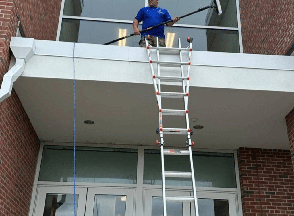 Expert window cleaning professionals in Central Florida washing large residential windows with crystal-clear finish.
