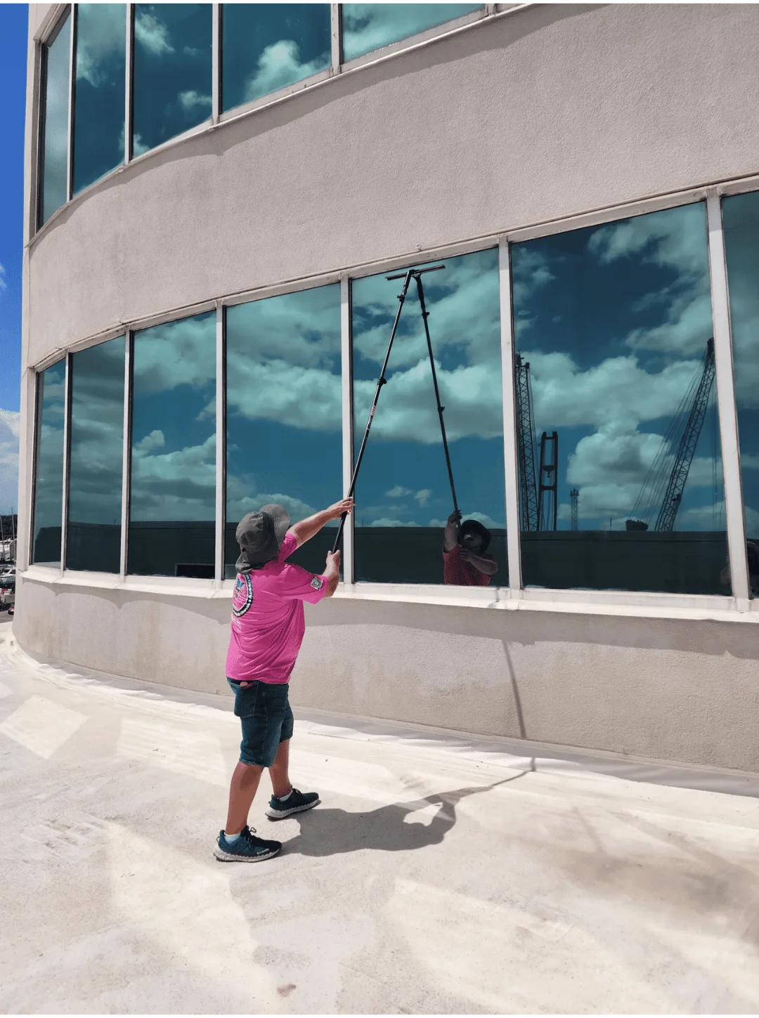 Professional commercial and residential window cleaning service in Long Island, New York cleaning large glass windows.