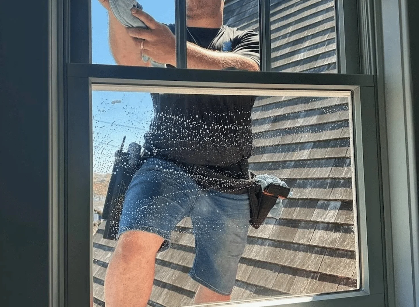 Expert window cleaning professionals washing large residential windows in Central Florida.